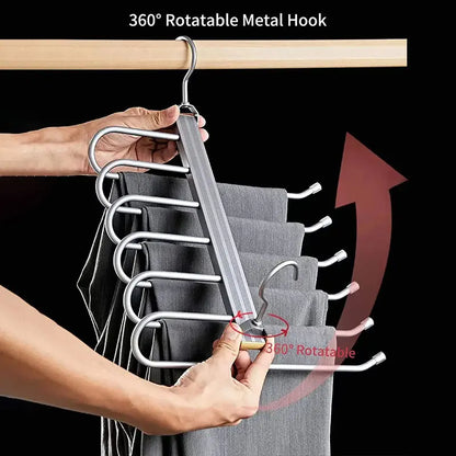 Hand holding multi-layer metal pants hanger with 360° rotatable hook and gray pants